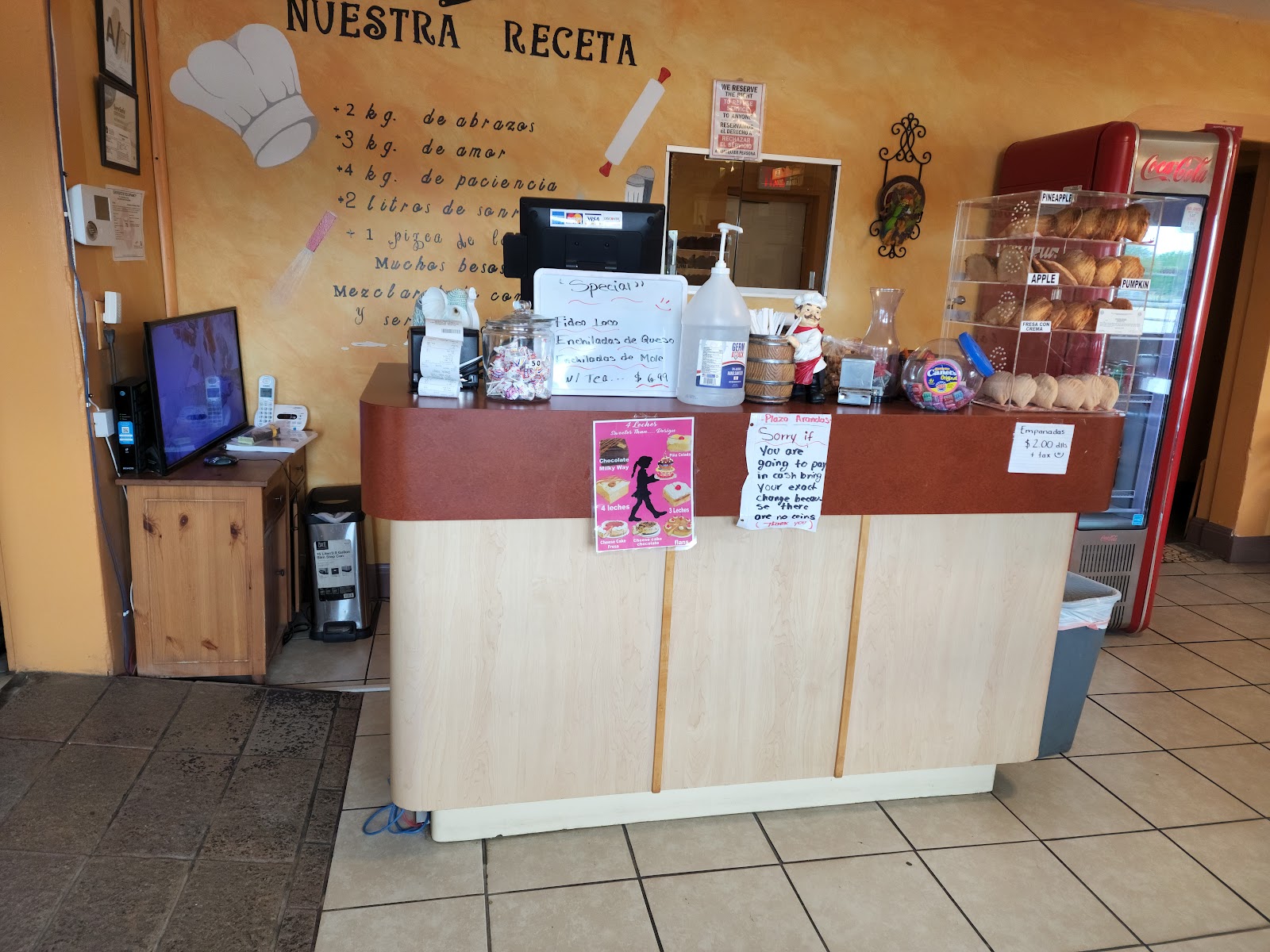 Cozy interior counter at Plaza Arandas decorated with a hand-painted family recipe mural