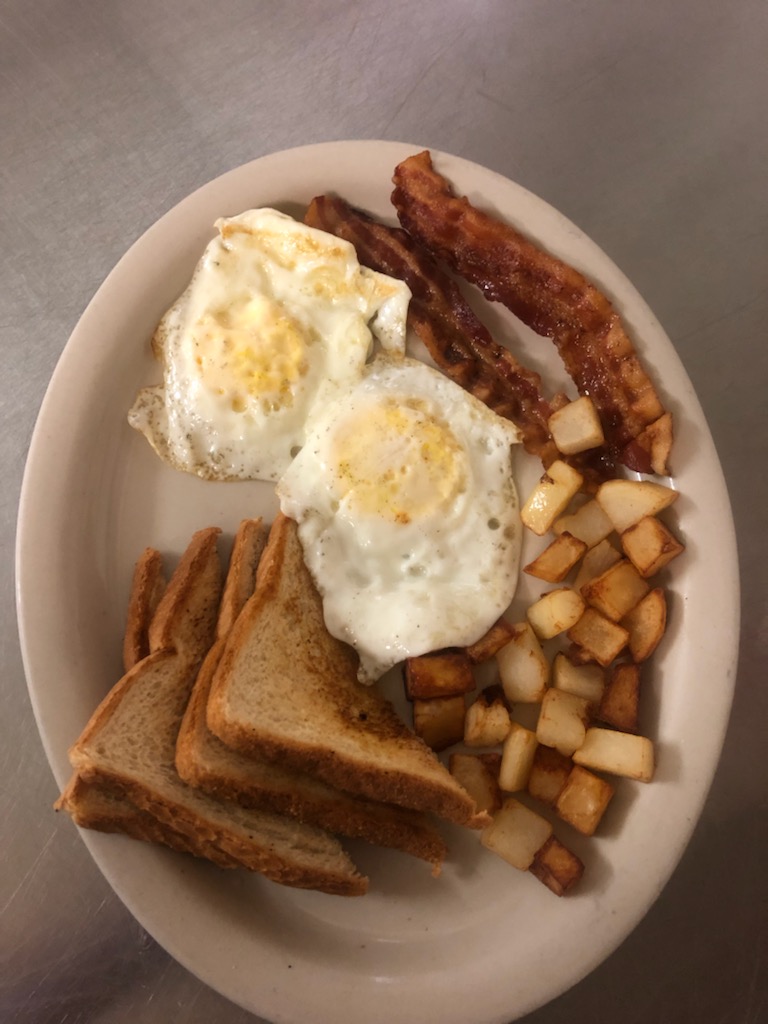 Fried eggs, bacon and toast breakfast plate